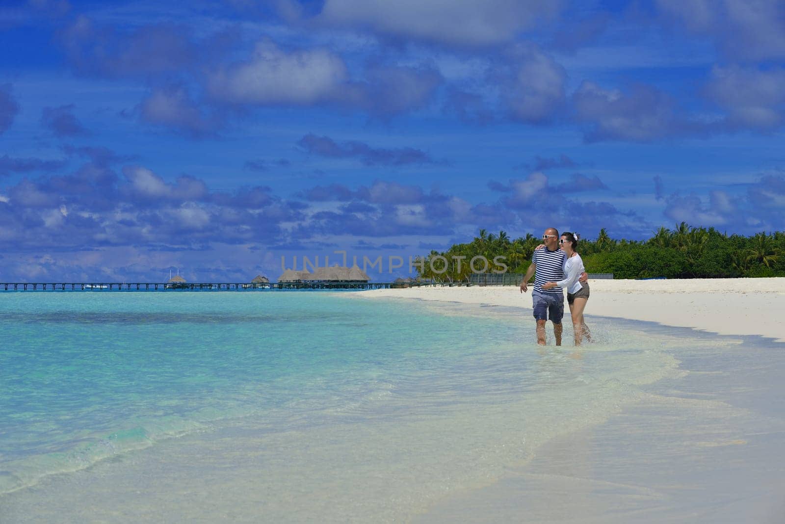 happy young  couple at summer vacation have fun and relax at beautiful sunny  day on beach