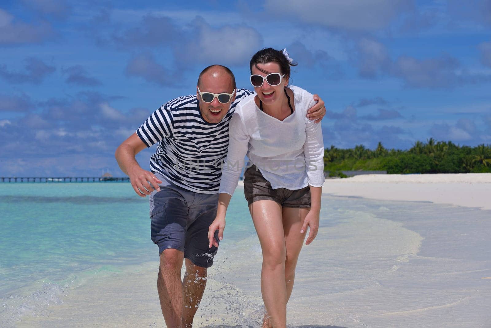 happy young  couple at summer vacation have fun and relax at beautiful sunny  day on beach