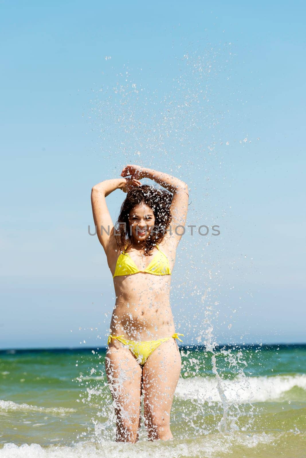 happy summer woman playing by the sea or ocean on vacation.