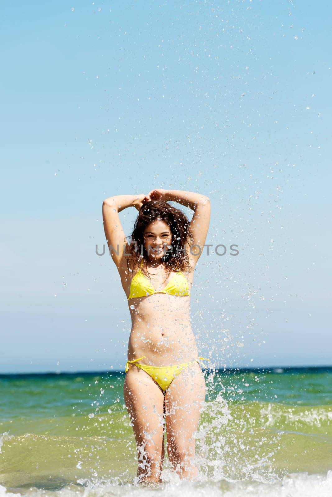 happy summer woman playing by the sea or ocean on vacation.