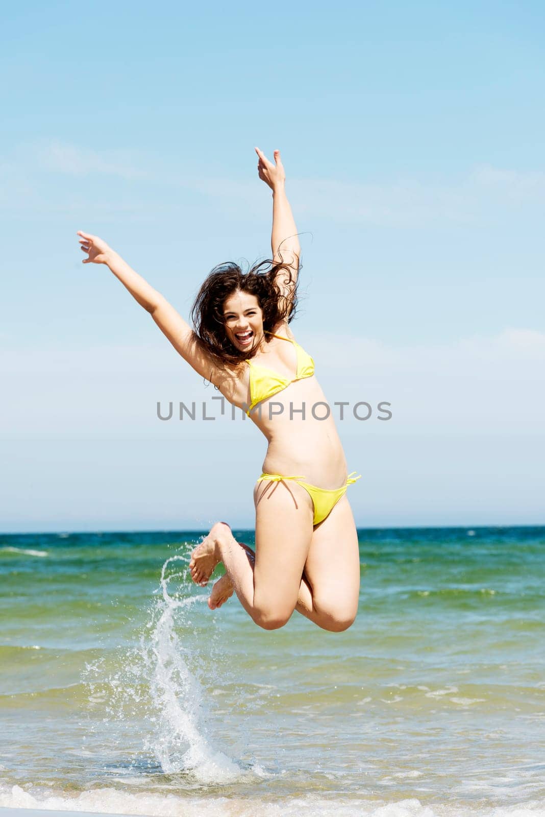 happy free girl jumping on the beach