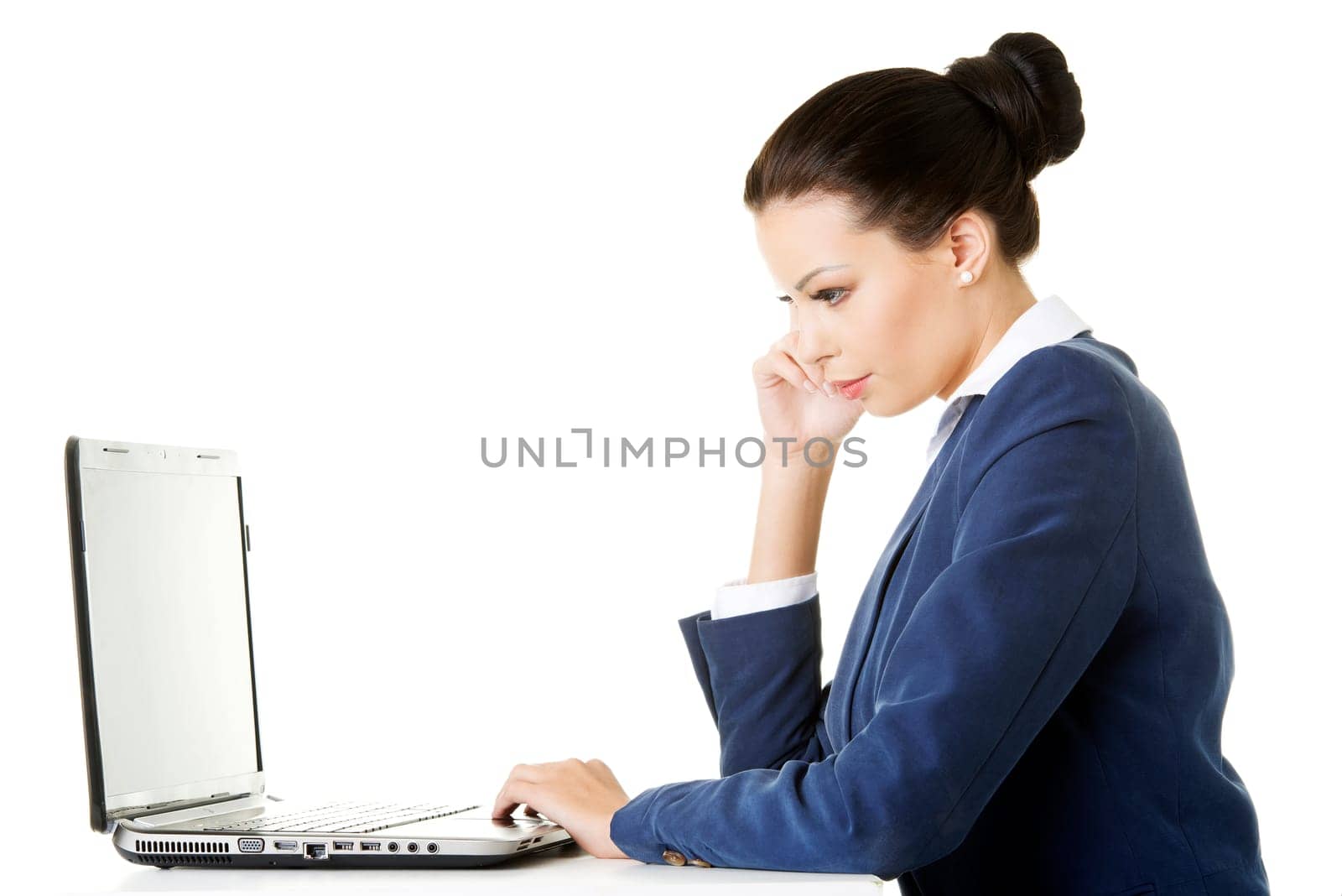 beautiful brunette businesswoman working on laptop computer isolated on white