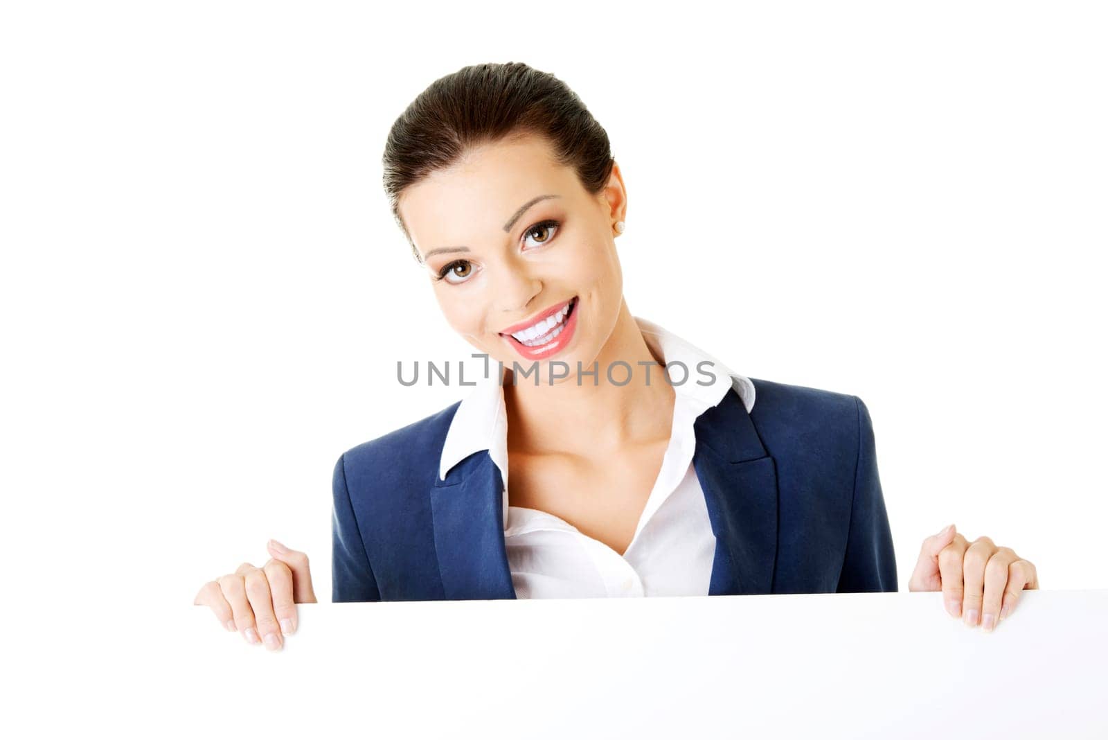 smiling attractive businesswoman showing blank signboard,over white background isolated