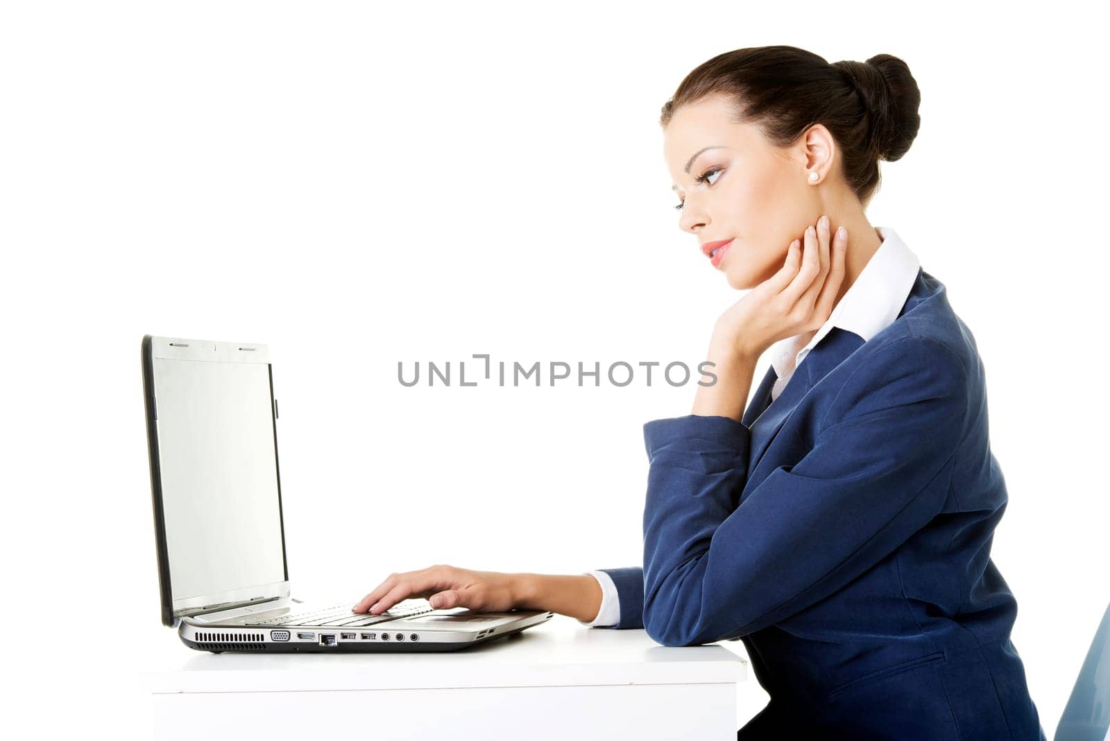 beautiful brunette businesswoman working on laptop computer isolated on white