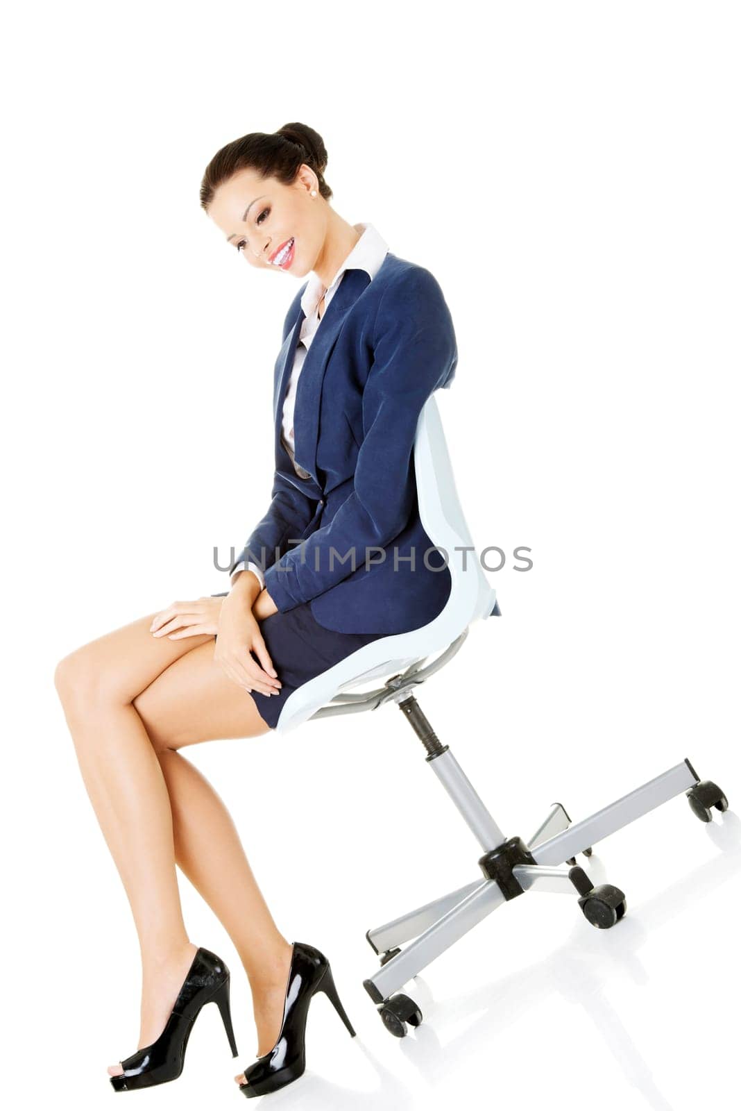 beautiful successful businesswoman sitting on the ofice chair and smiling,isolated on white