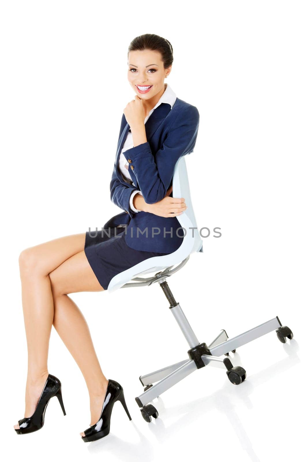 beautiful successful businesswoman sitting on the ofice chair and smiling,isolated on white