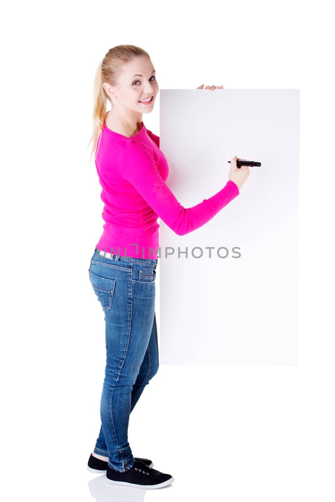 happy beautiful woman writing with a marker on blank board. student or businesswoman.