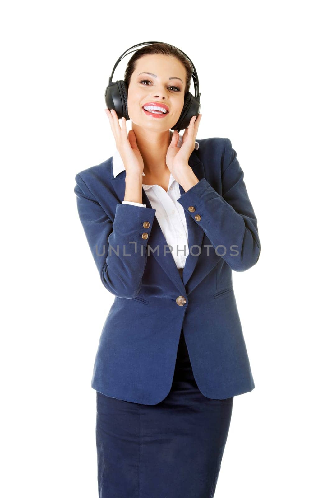 happy attractive businesswoman listening the music through headphones. isolated on white.