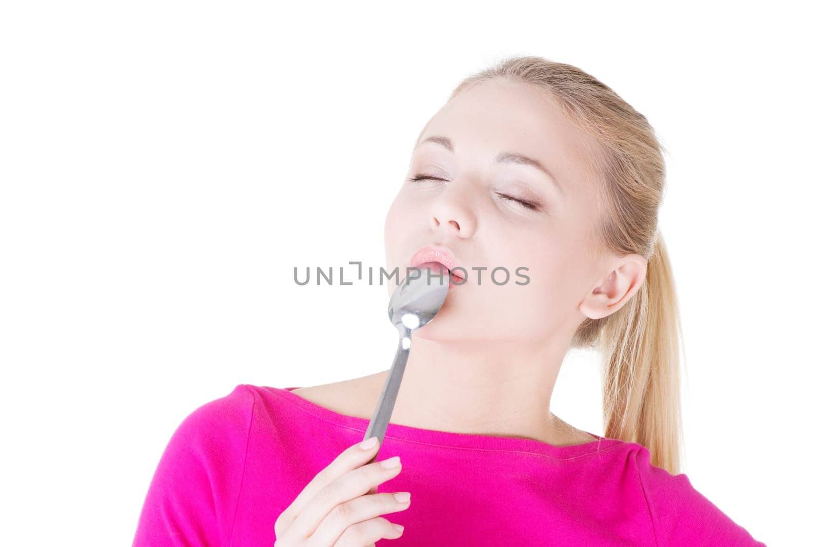 portrait of young smiling woman with spoon in her mouth (pleasure from eating),isolated on white