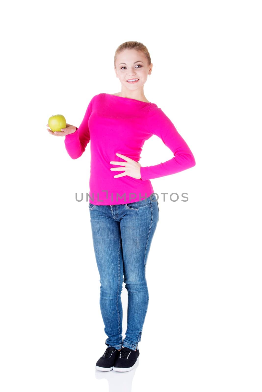 young woman holding green fresh apple in hand,isolated over white background
