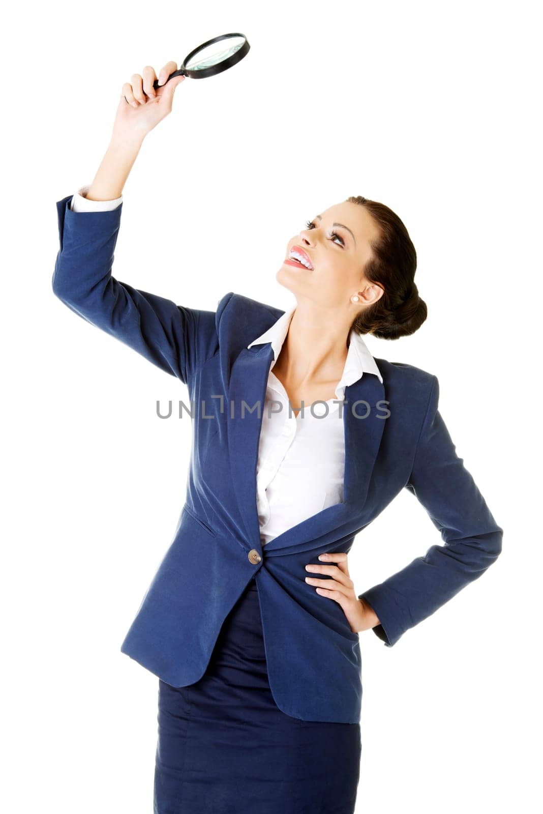 young attractive business woman looking into a magnifying glass,isolated on white background