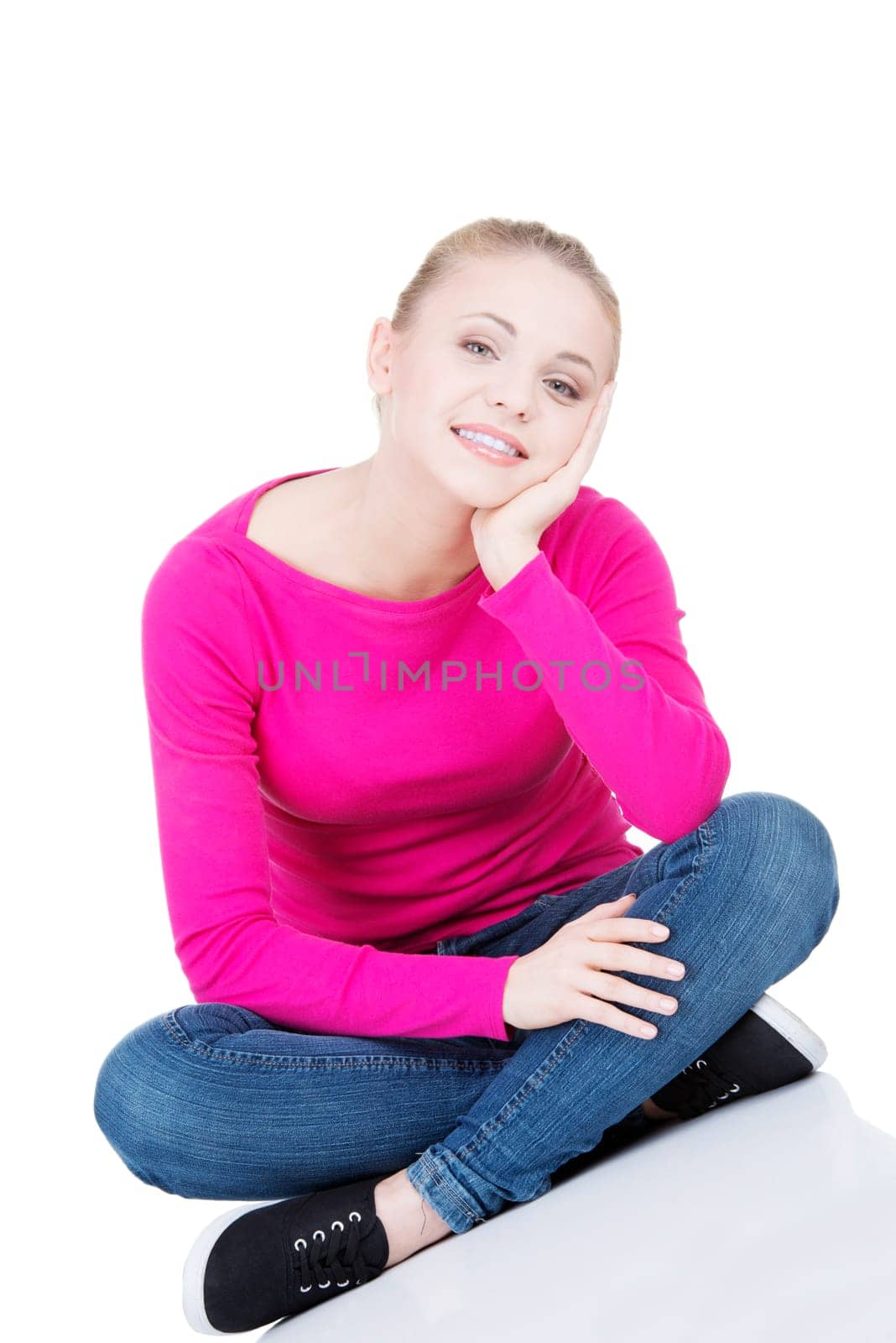 yong happy casual woman sitting on floor,isolated on white background