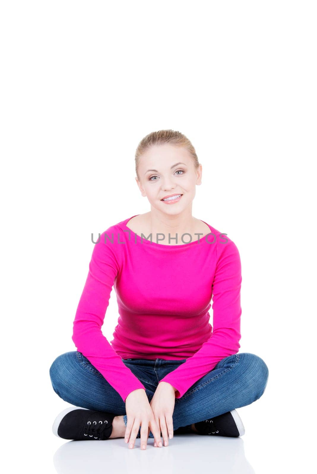 yong happy casual woman sitting on floor,isolated on white background