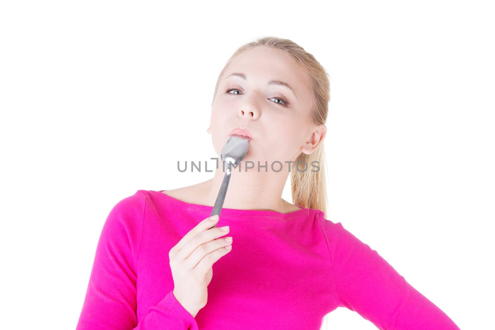 portrait of young smiling woman with spoon in her mouth (pleasure from eating),isolated on white