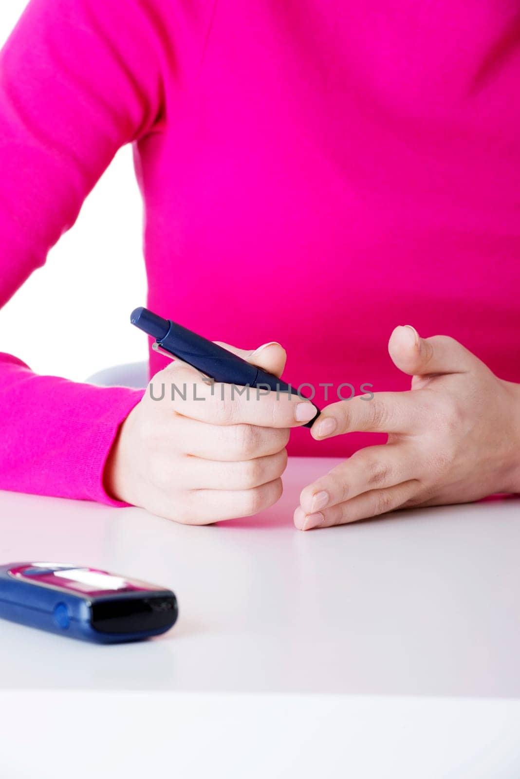 diabetes patient measuring glucose level blood test using ultra mini glucometer and small drop of blood from finger isolated on a white background