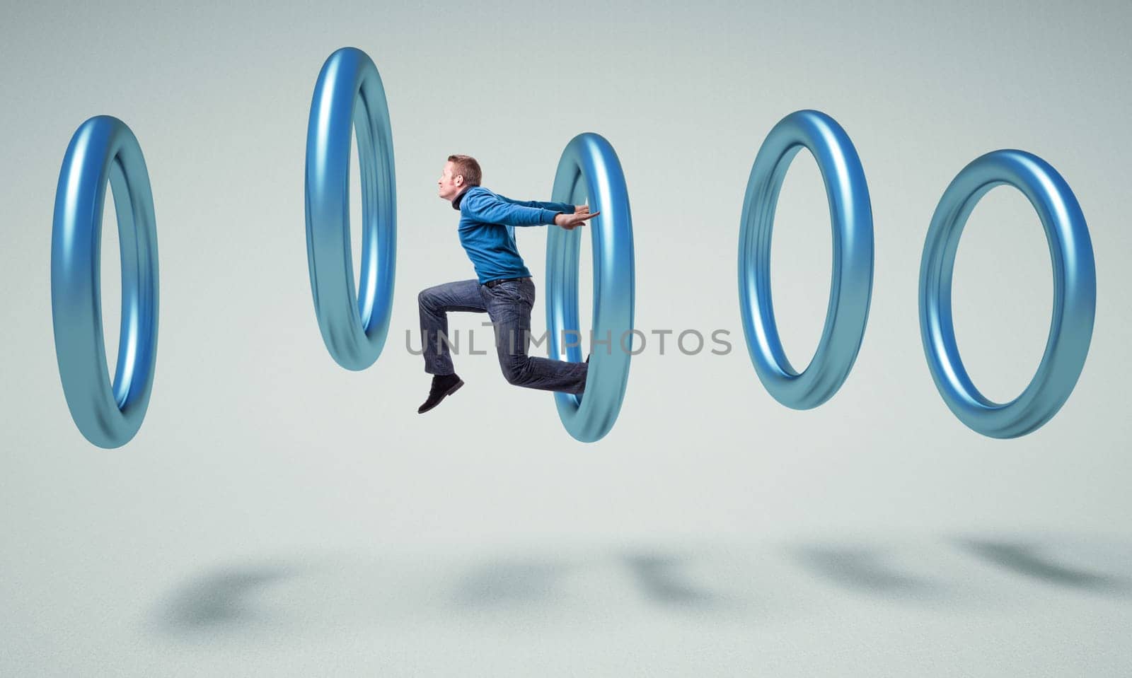 caucasian man jump in a metal 3d ring