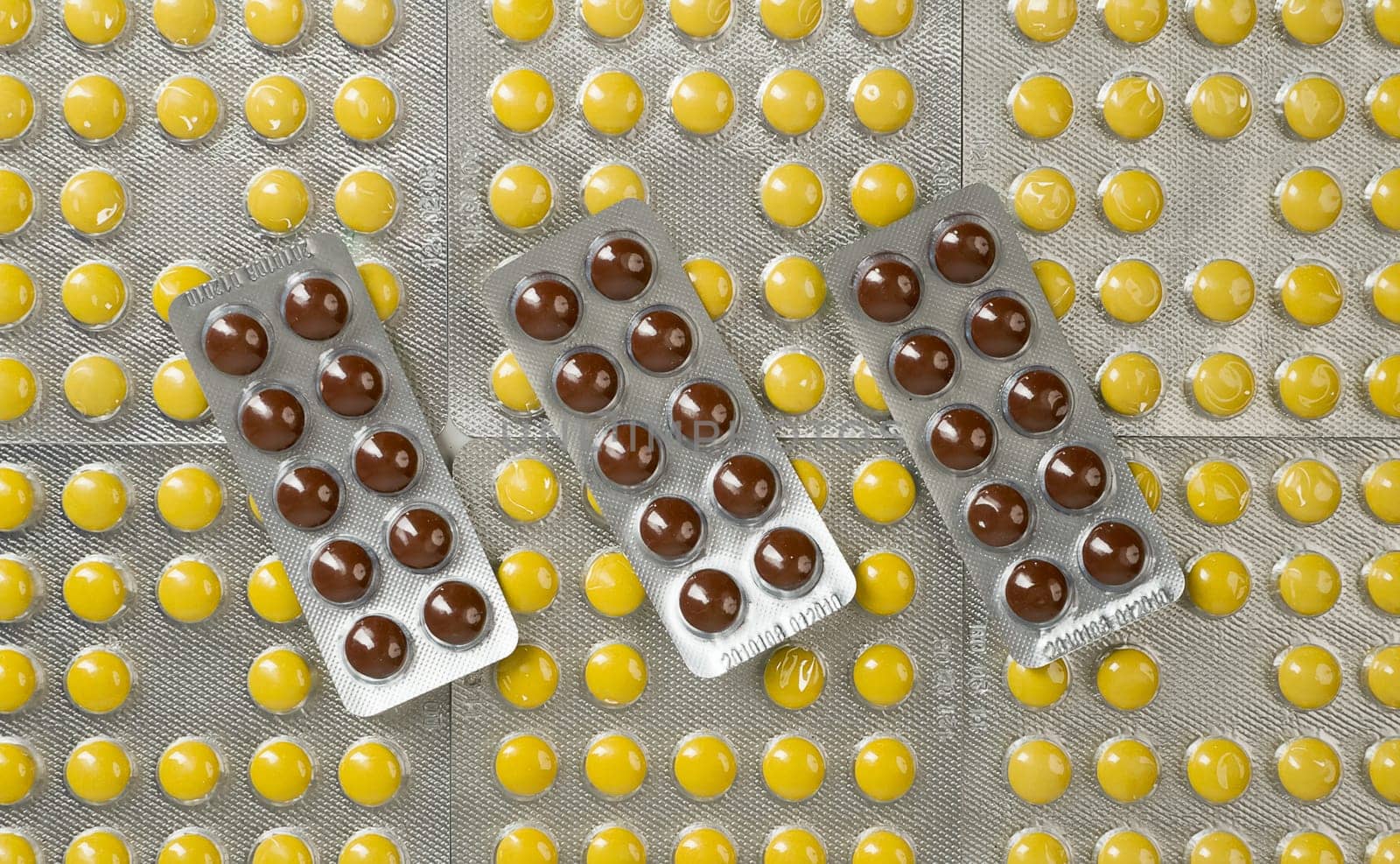 many pills of different colors in blister packs