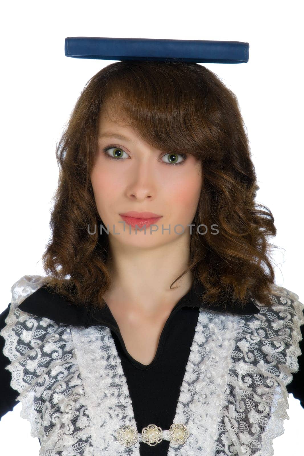 beautiful teen girl holding a book on his head