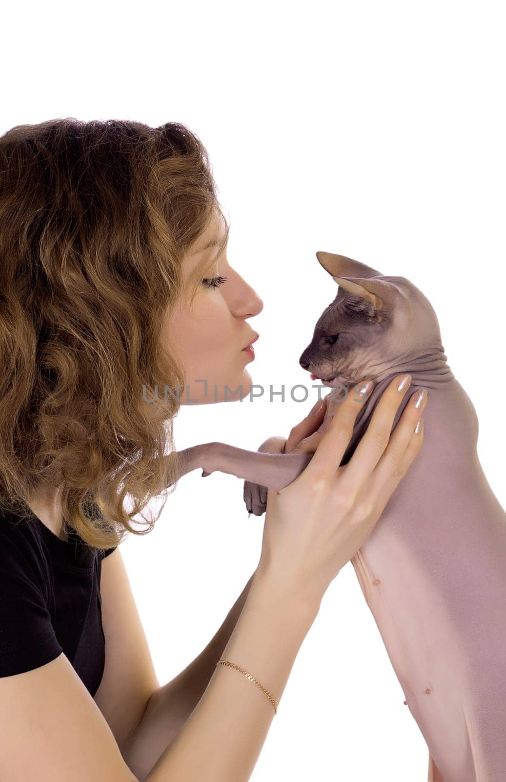 girl kissing a cat on a white background in profile