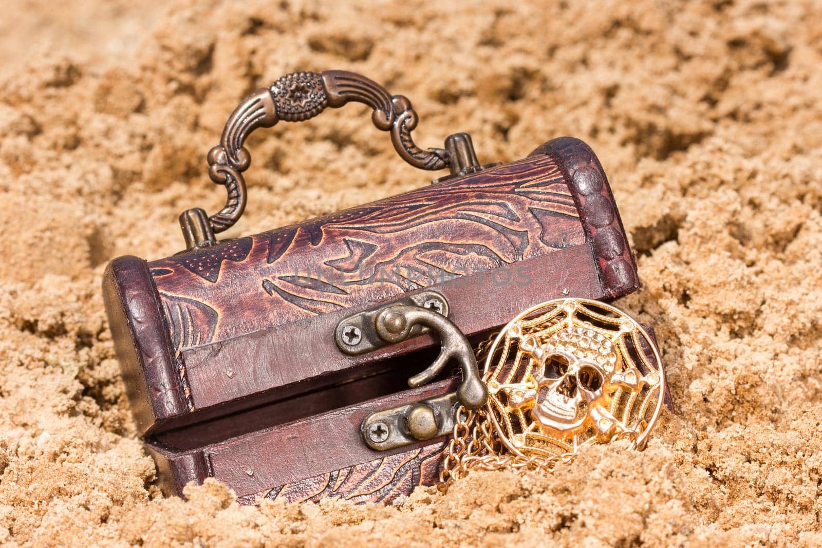 Pirate treasure chest with  the gold  on a sandy beach