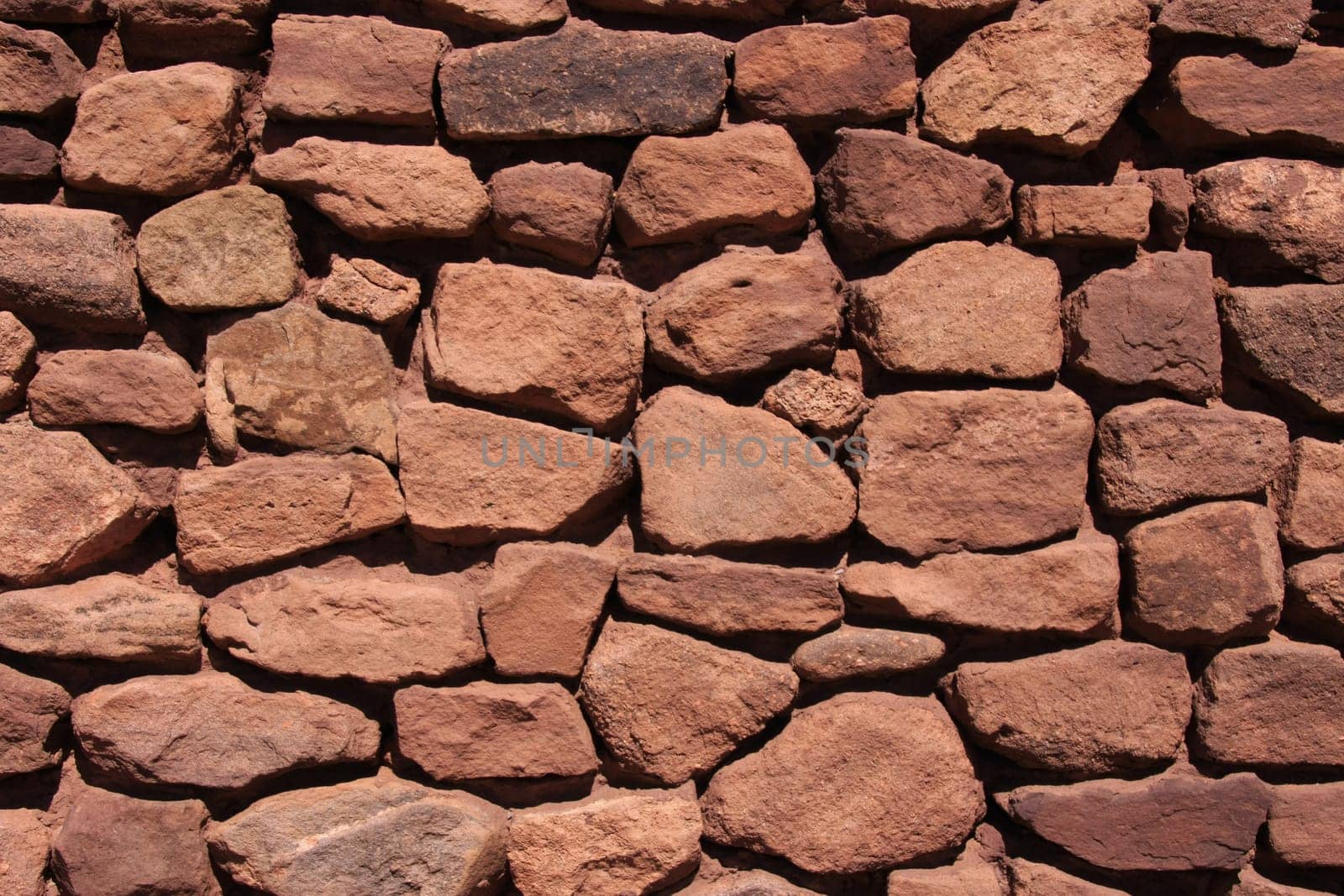 Background of reddish natural stone wall