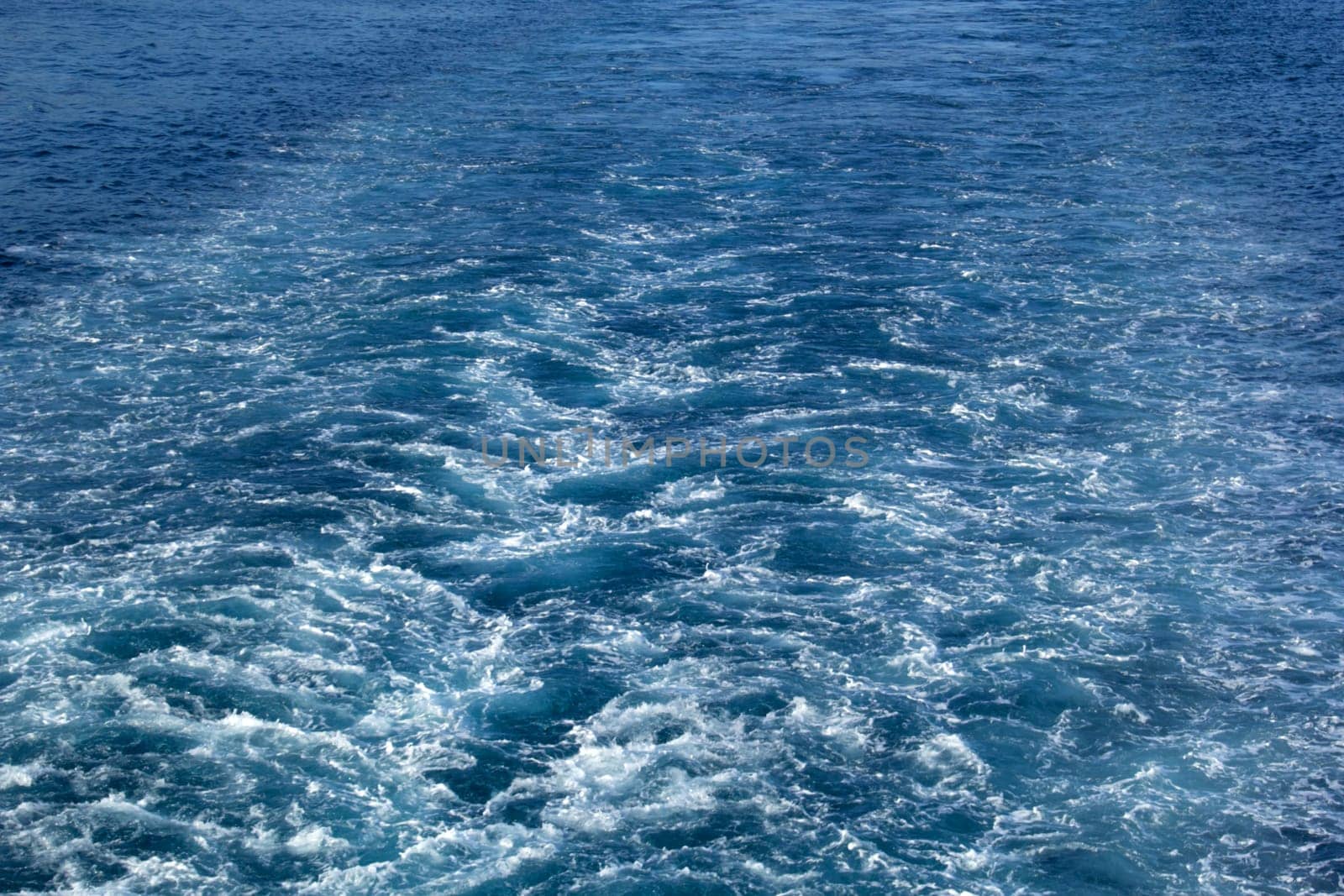 Background of waves in the ocean behind a ship