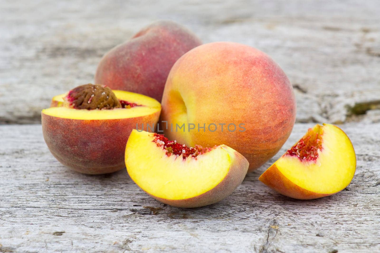 fresh peaches on old wooden background
