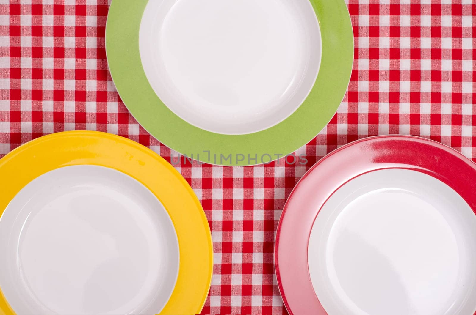 Red,green,and yellow table on a table with checkered tablecloth