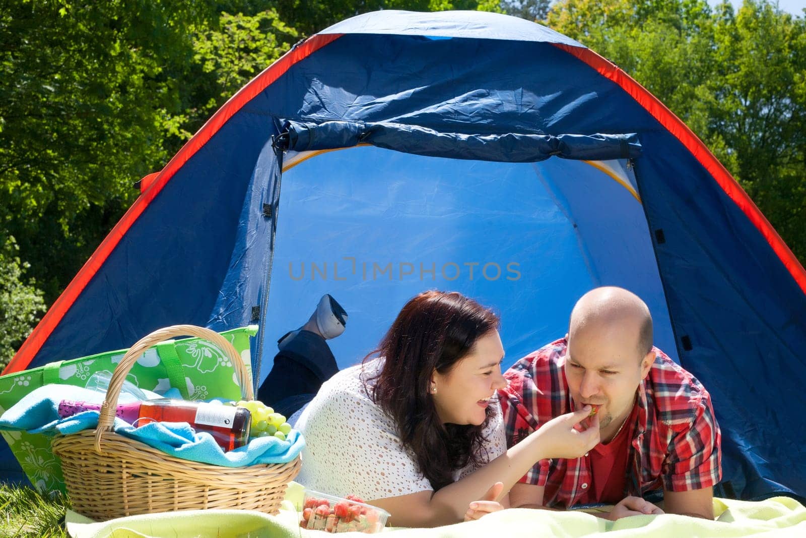 Happy young couple is relaxing on a camping