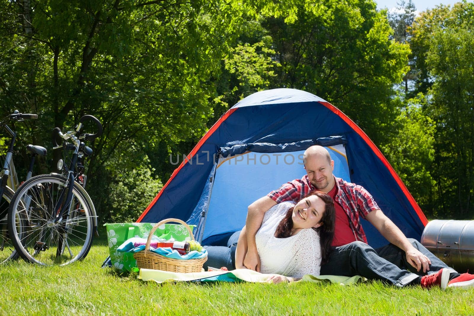 Happy young couple is relaxing on a camping