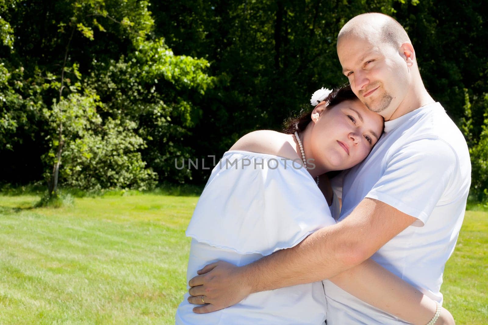 Happy young couple dressed white in the nature