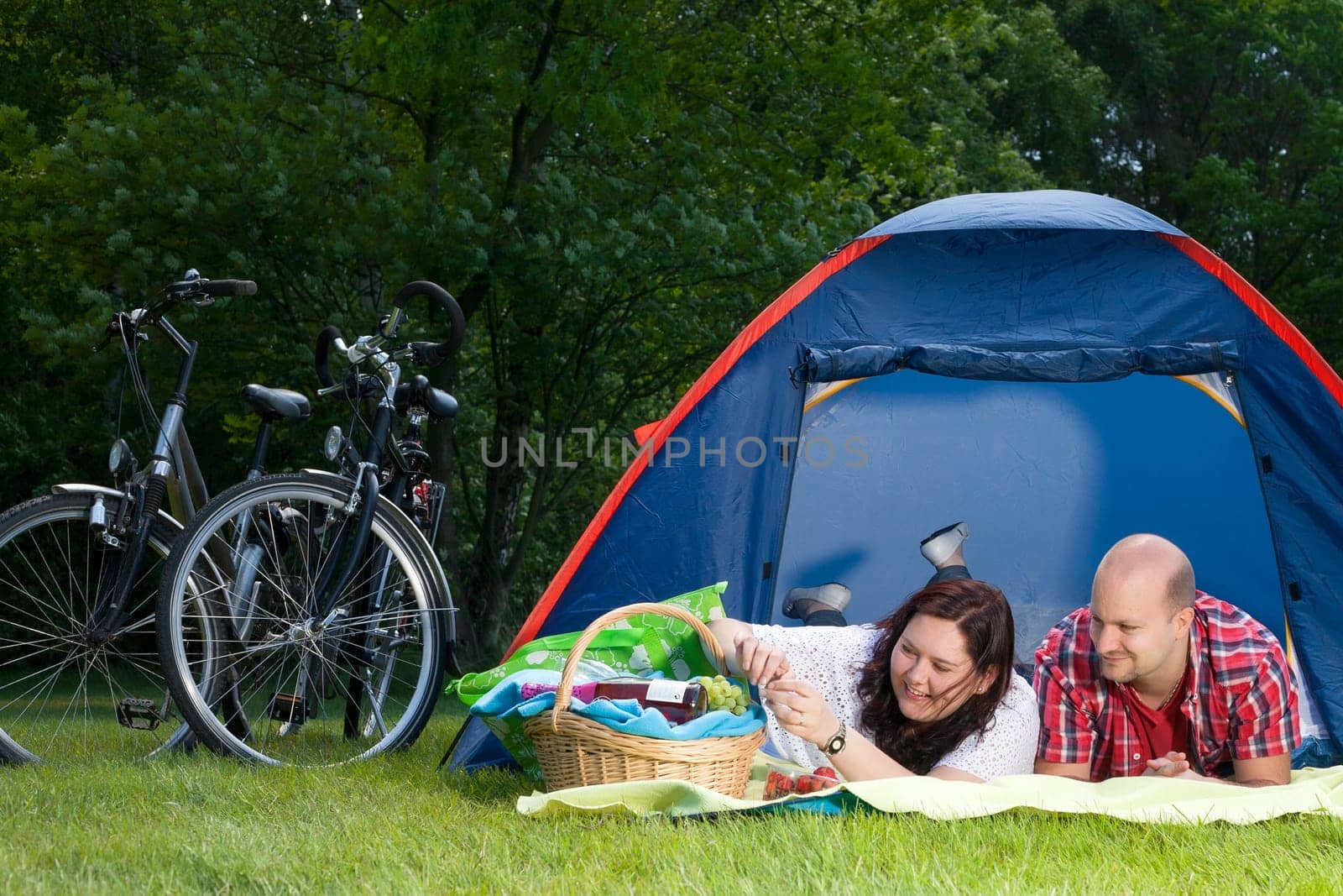 Happy young couple is relaxing on a camping