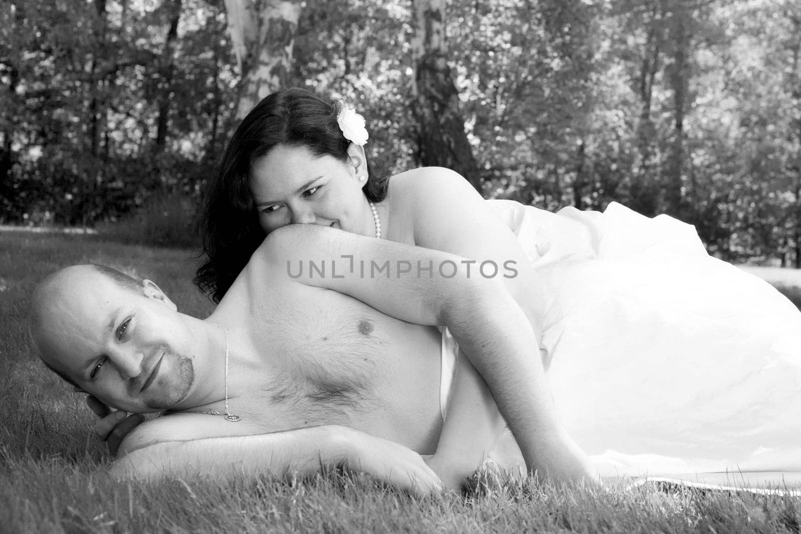 Happy young couple dressed white in the nature
