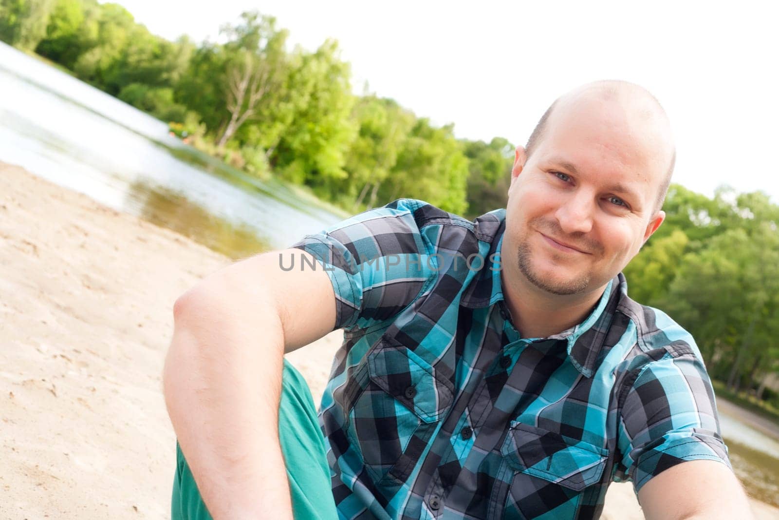 Happy young couple is having fun on a windy park beach