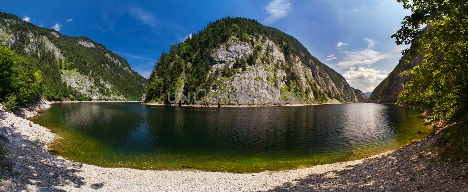 very large panoramic view of the lake in the mountains