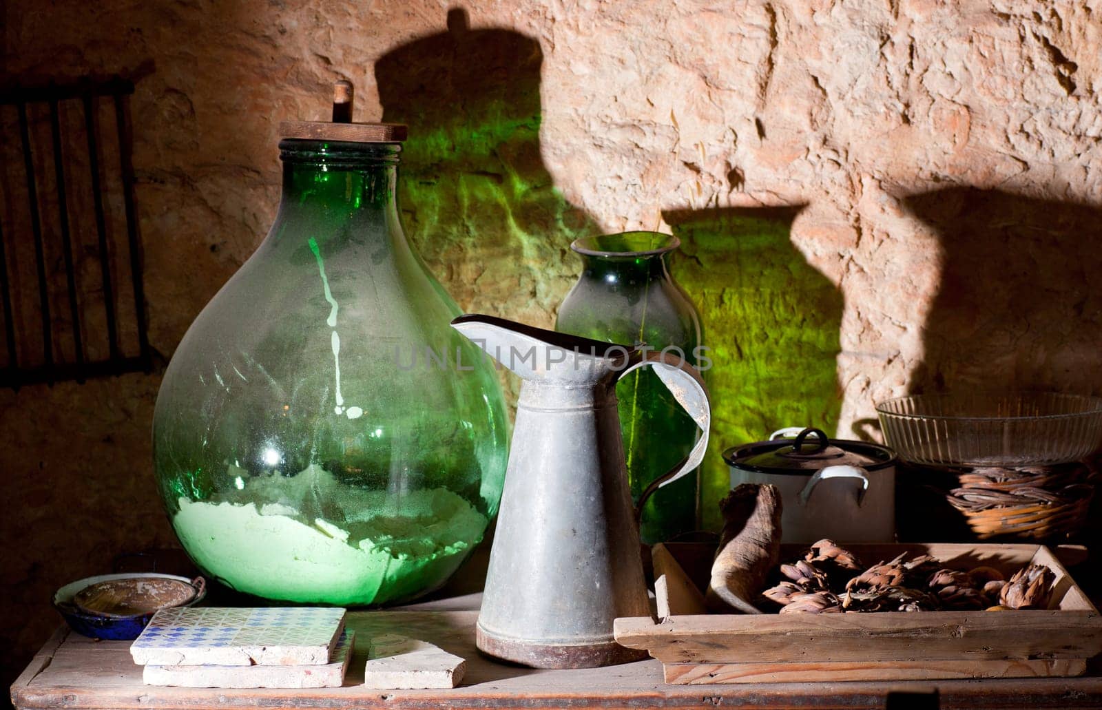 Photo of an iron pitcher and glass demijohn