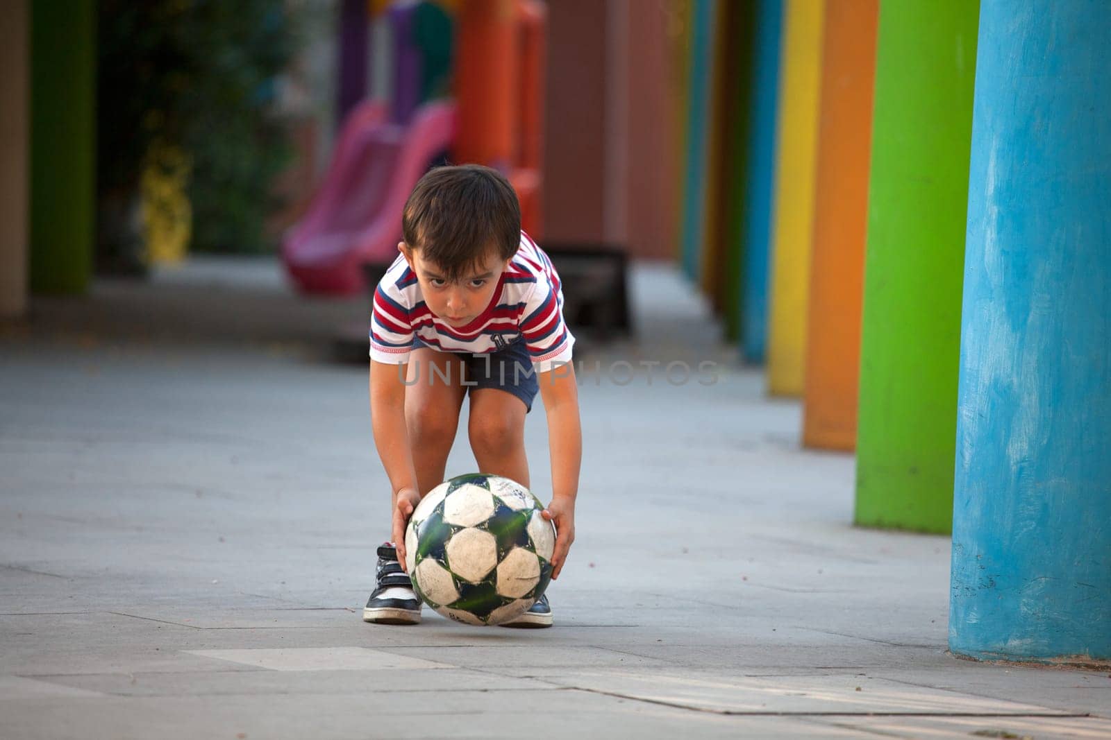Cute boy is holding a soccer ball