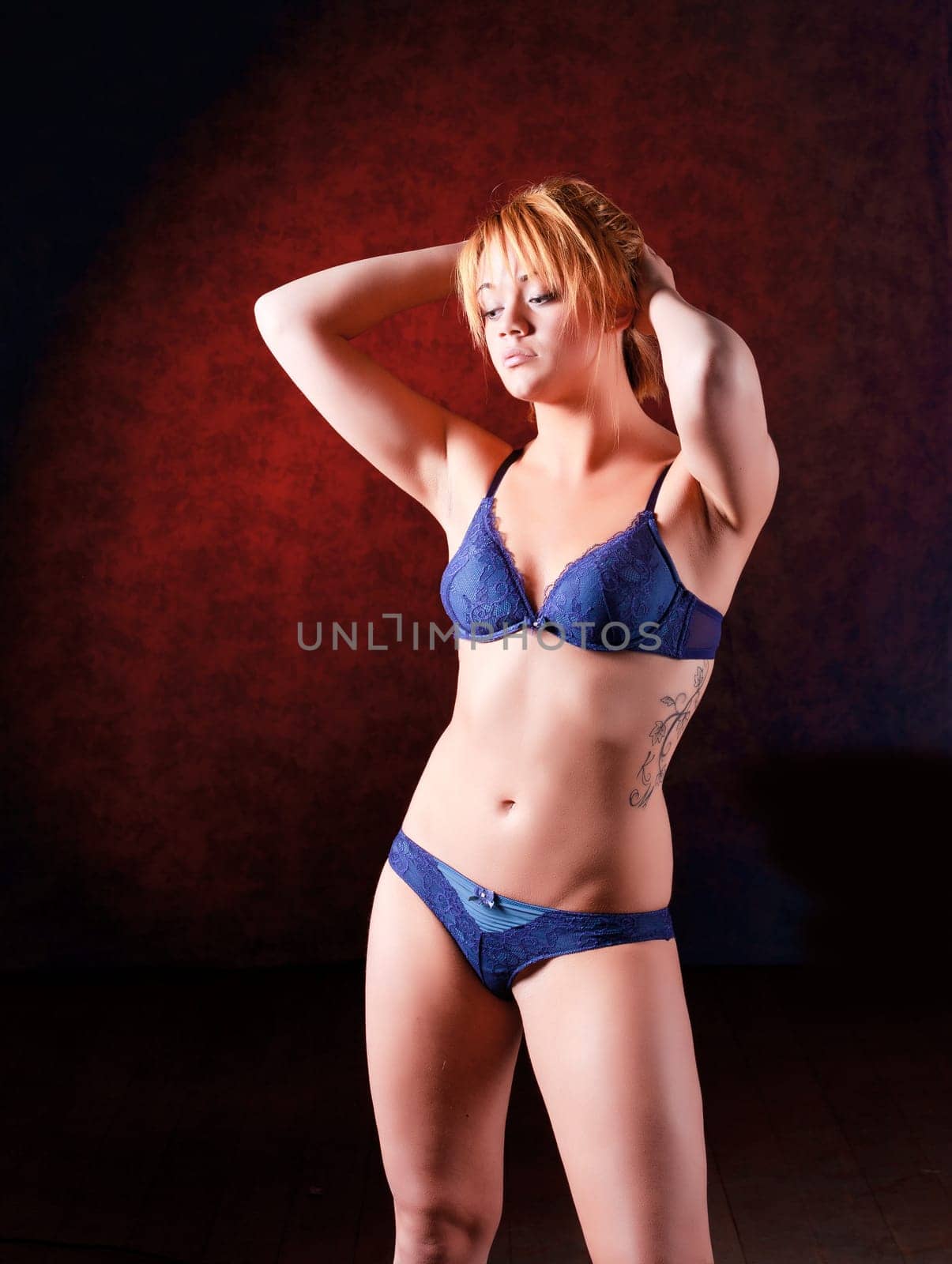 Sensual blonde girl in underwear on dark background