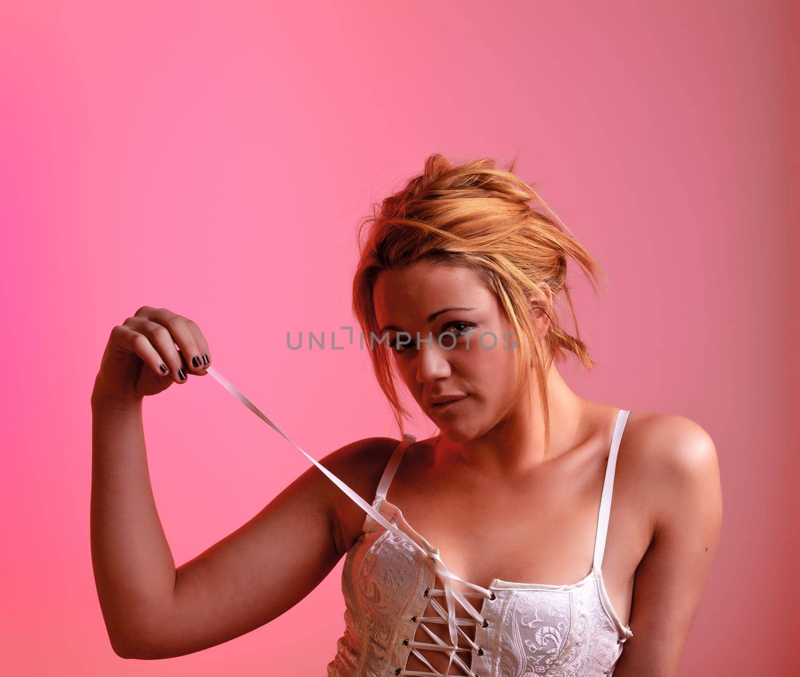 Sensual blonde girl on pink background