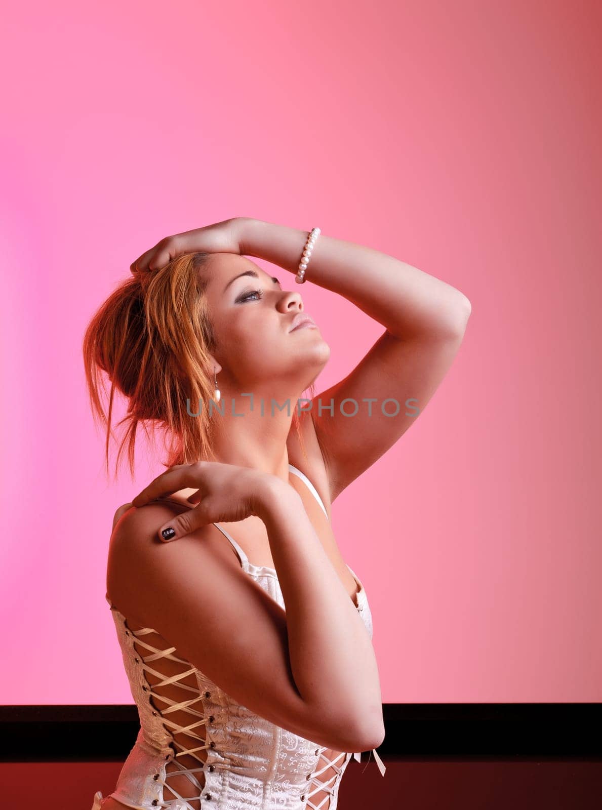 Sensual blonde girl on pink background