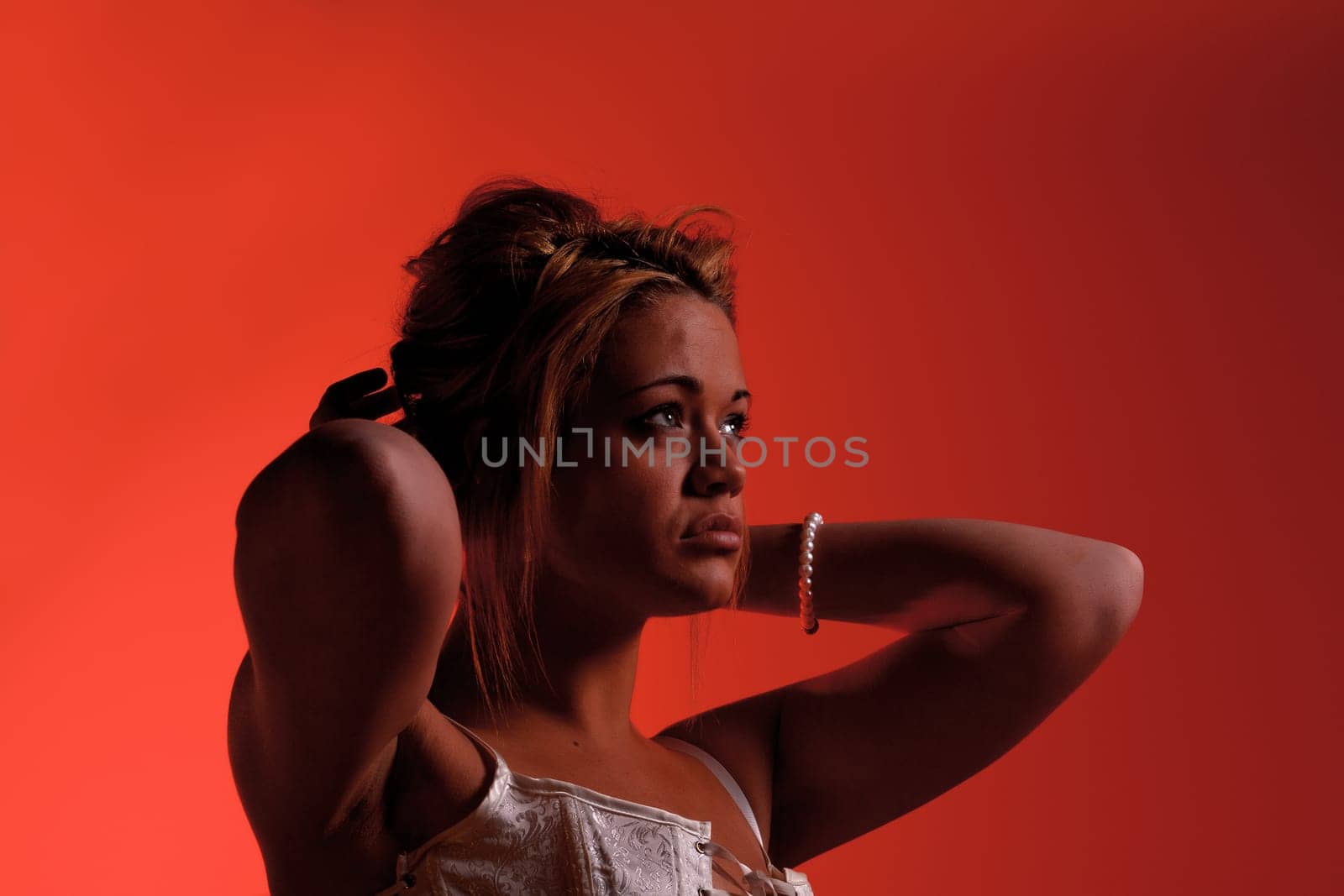 Sensual blonde girl on red background