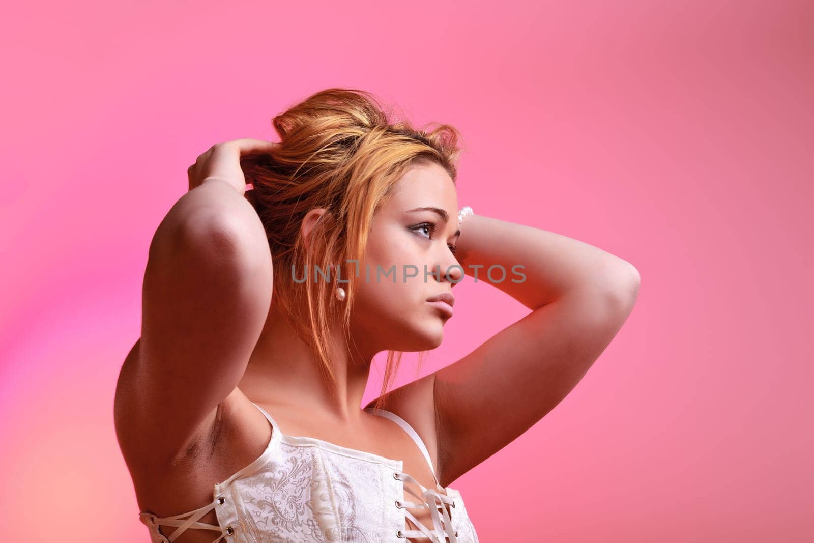 Sensual blonde girl on pink background