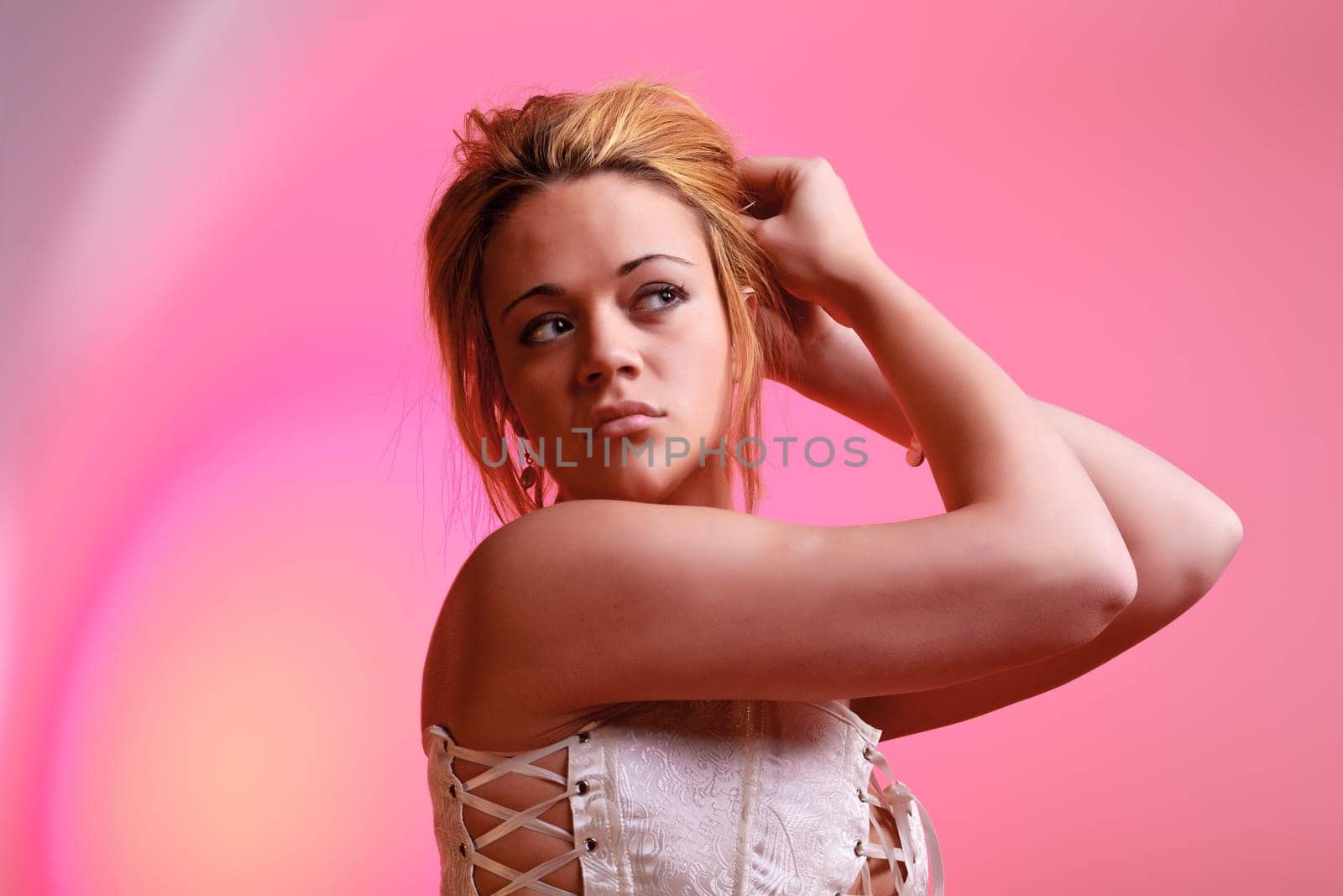 Sensual blonde girl on pink background