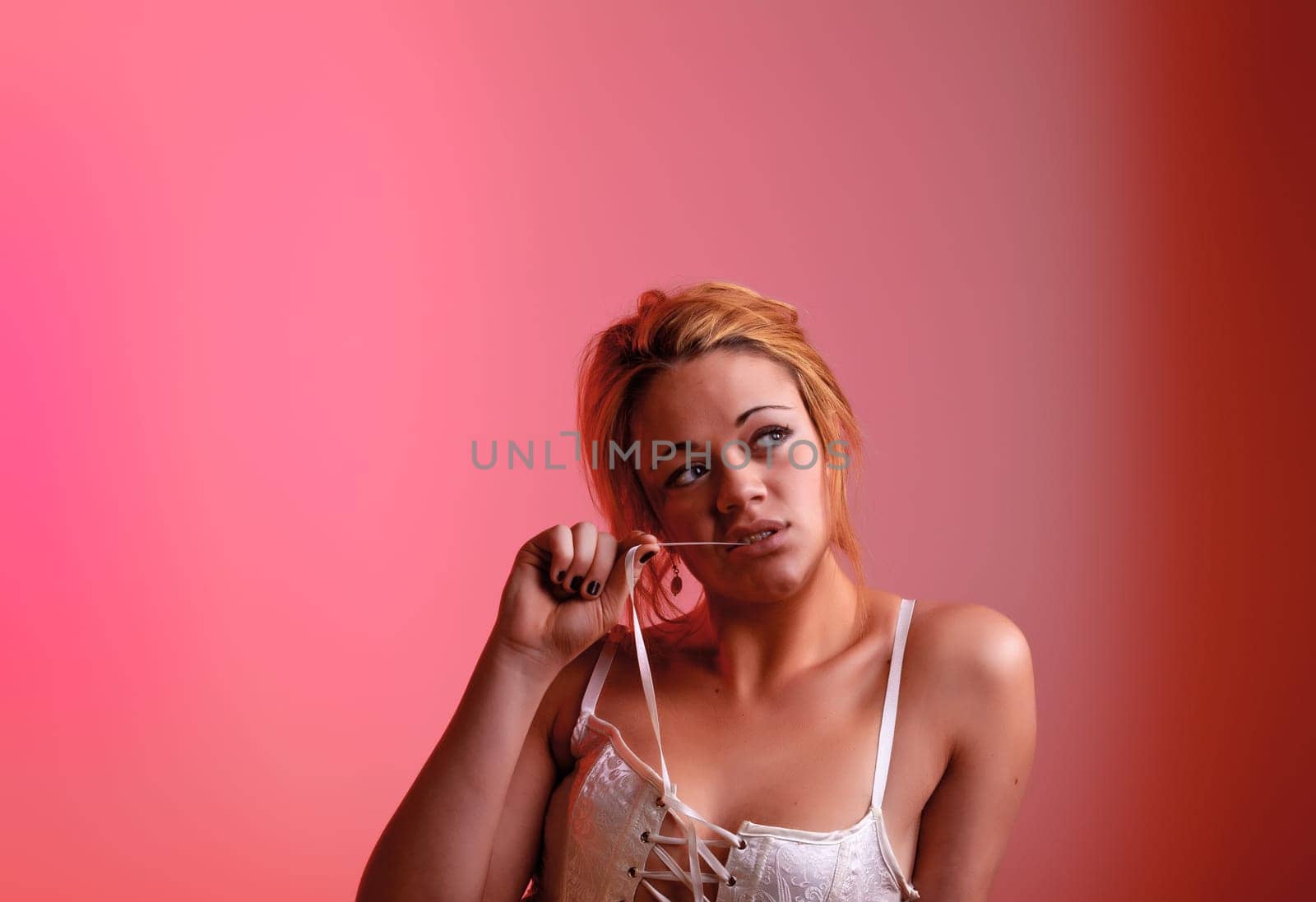 Sensual blonde girl on pink background
