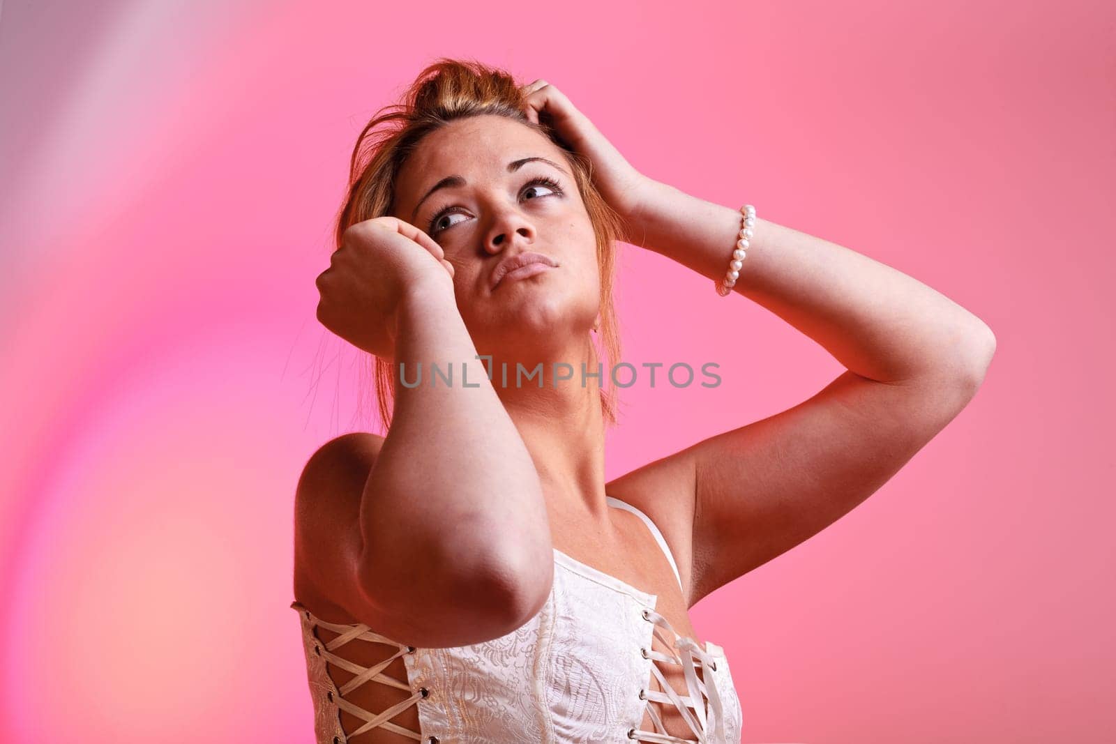 Sensual blonde girl on pink background