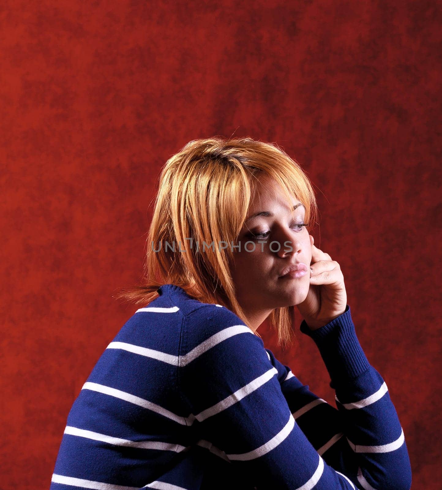 Girl sitting on the stool on red background