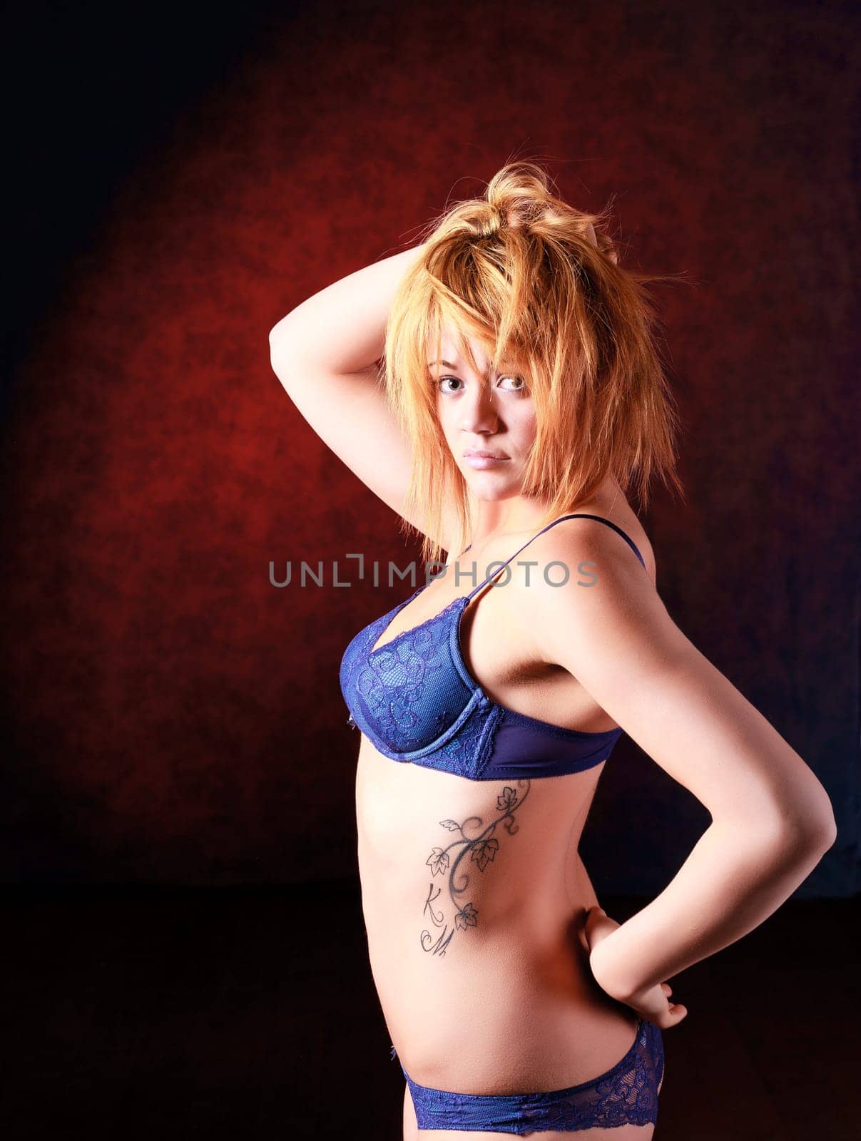 Sensual blonde girl in underwear on dark background