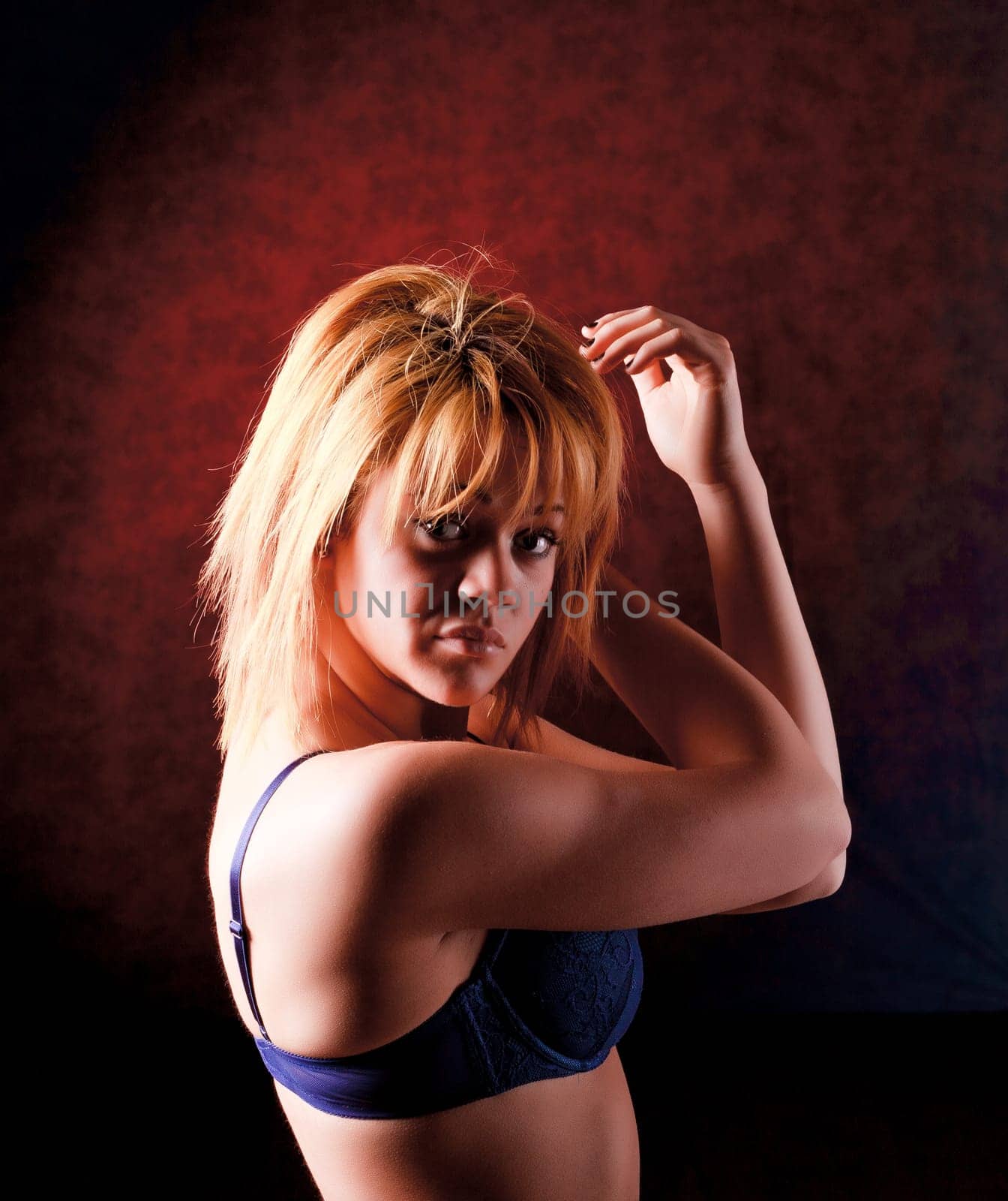 Sensual blonde girl in underwear on dark background