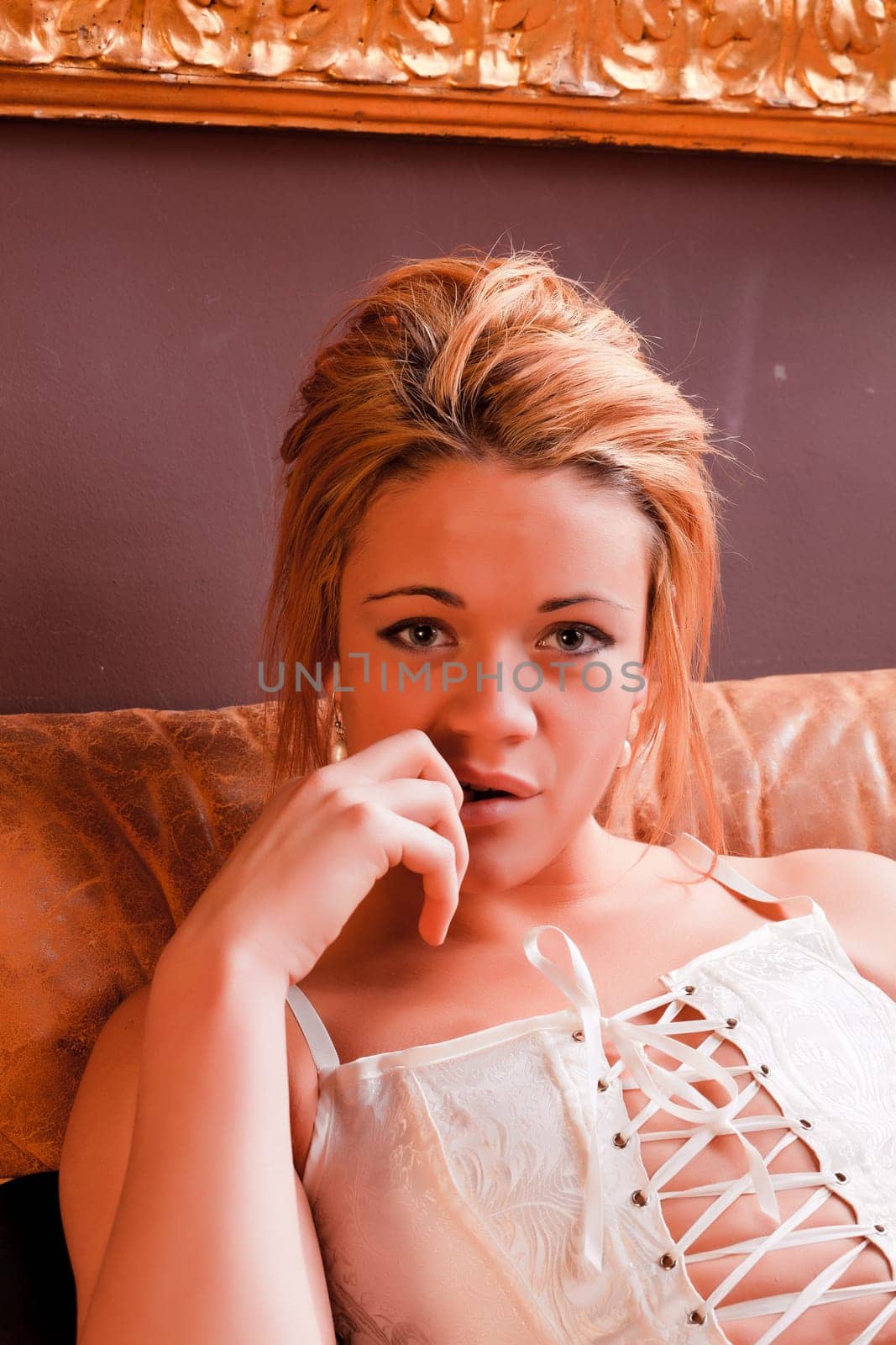Sensual blonde girl in underwear on armchair