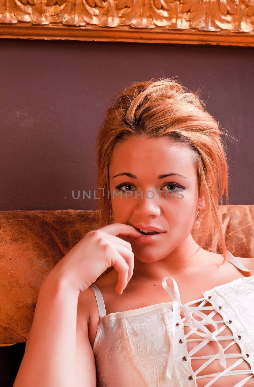 Sensual blonde girl in underwear on armchair